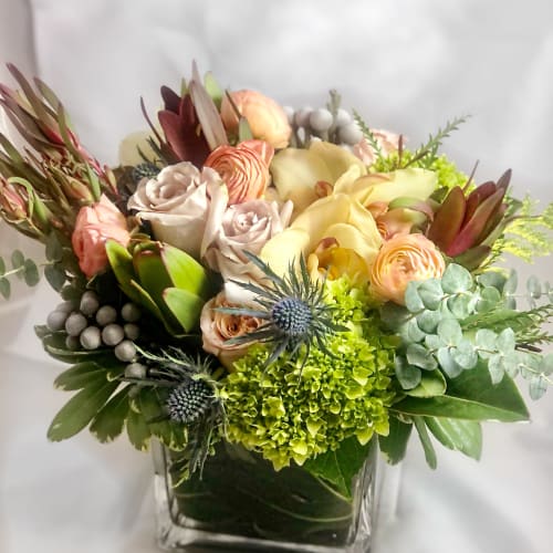 Mixed pastel bouquet in a square glass vase