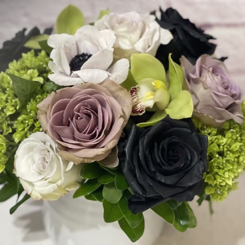 Bouquet of roses and orchids with bright green filler