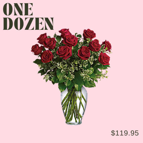 Dozen red roses in a clear glass vase