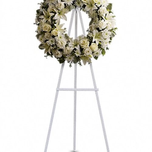 White floral wreath on a standing easel