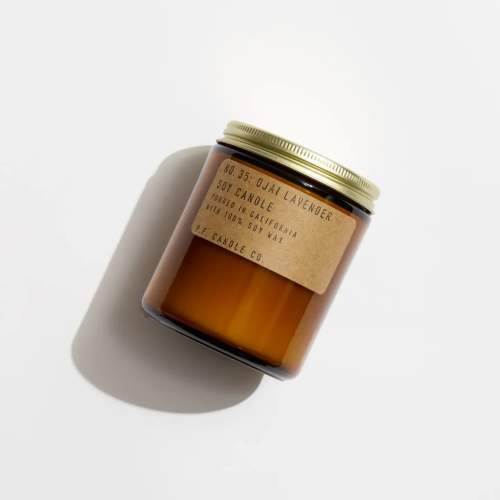 Amber jar candle with a gold lid and paper label