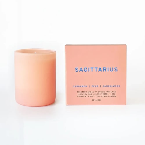 Peach scented candle beside a matching Sagittarius box