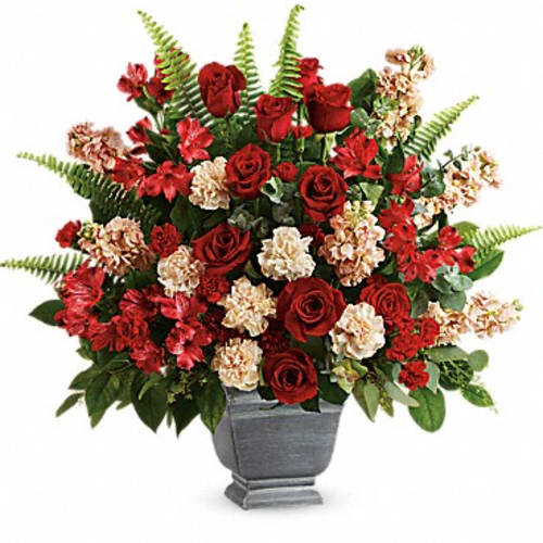 Red roses and carnations in a gray urn vase