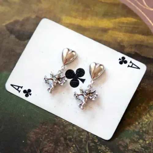 Ace playing card with heart-shaped earrings attached