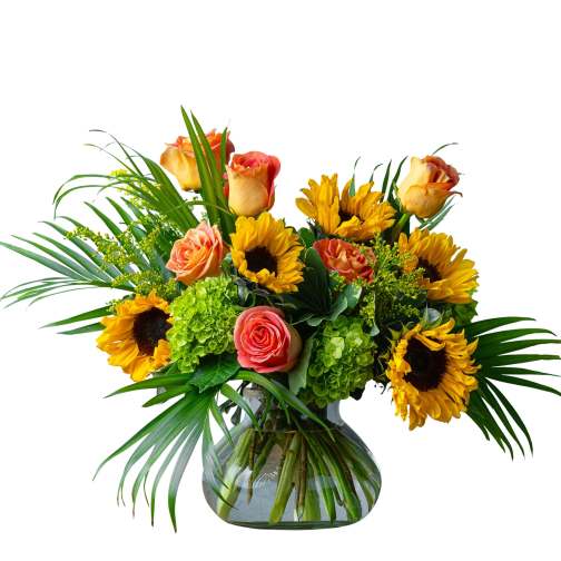 Bouquet of sunflowers and peach roses in a glass vase