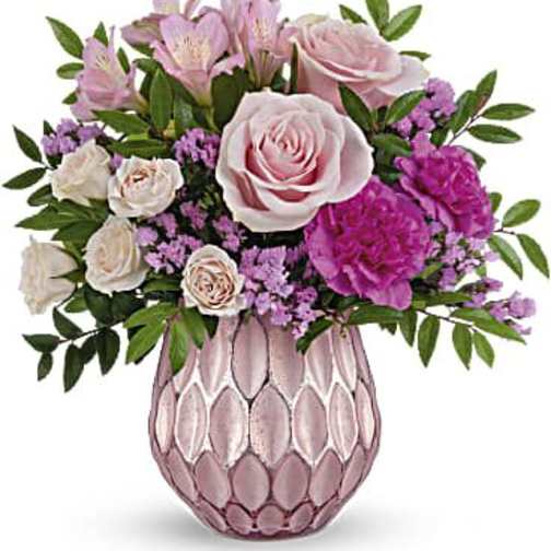 Pink and white flower arrangement in a pink textured vase