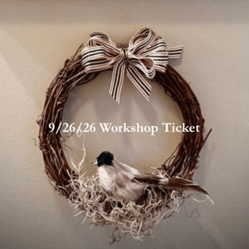Twig wreath with a striped bow and a small bird decoration