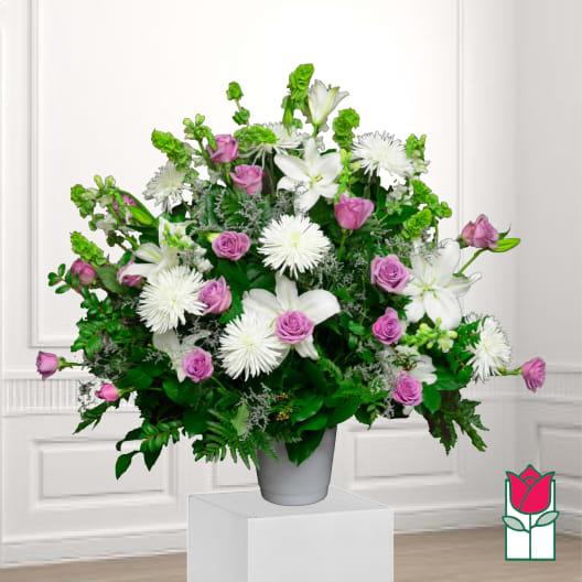 White lilies and pink roses in a gray vase