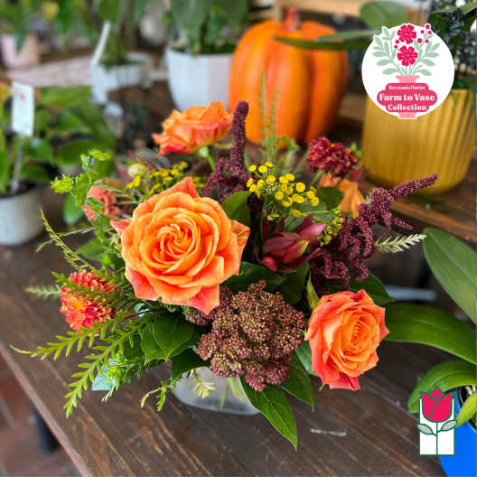 Orange roses in a mixed bouquet with purple and yellow accents