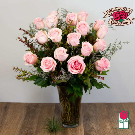 Pink roses arranged in a tall glass vase