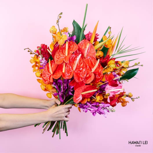 Bright tropical bouquet with red anthuriums and orange orchids