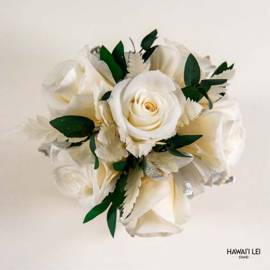 White rose bouquet with green leaves and silver ribbon accents
