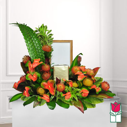 Tropical floral arrangement with orange anthuriums and red pincushion blooms