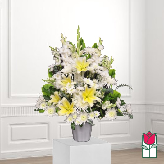 White and yellow floral arrangement in a gray vase