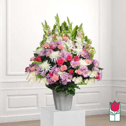 Mixed bouquet of pink, white, and lavender flowers in a gray vase
