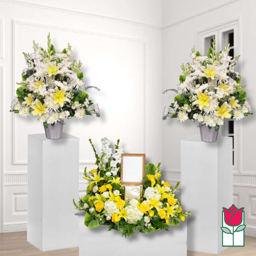 White and yellow floral funeral arrangement with matching pedestal sprays