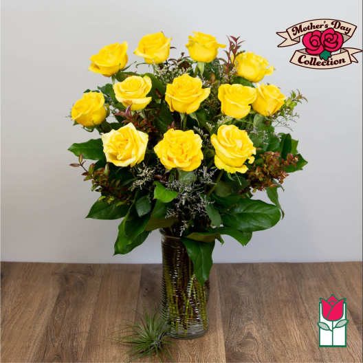 Yellow roses arranged in a clear glass vase