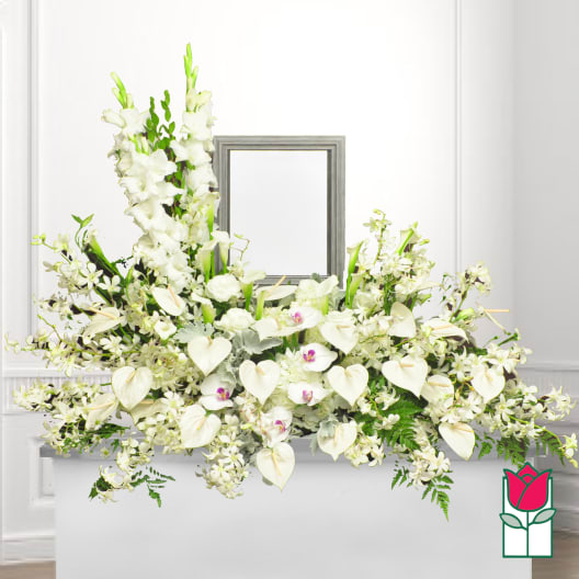 White floral casket spray with orchids and calla lilies