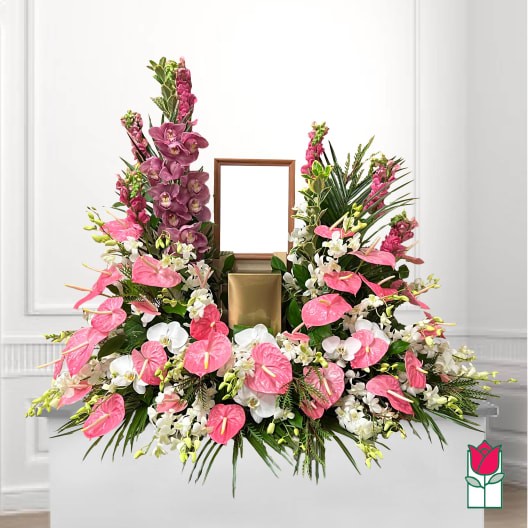 Large floral arrangement with pink anthuriums, white orchids, and purple orchids