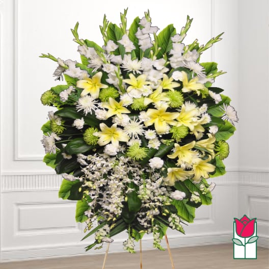 Large standing floral spray with yellow lilies and white flowers