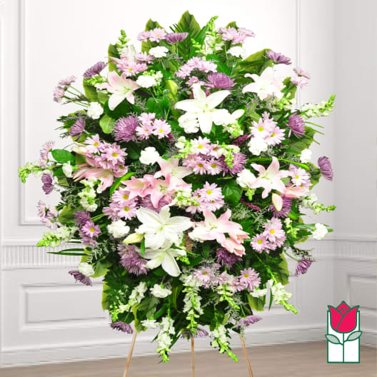 Large standing spray of pink and white flowers on an easel