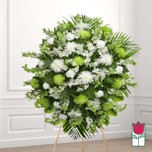 Standing floral spray of white and green flowers on a wooden easel