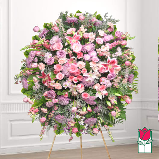 Large pink and lavender funeral spray on a stand