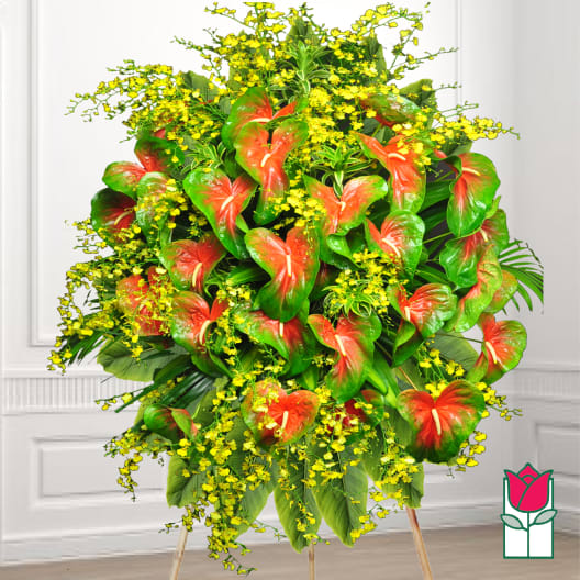 Large standing floral spray with red anthuriums and yellow filler flowers