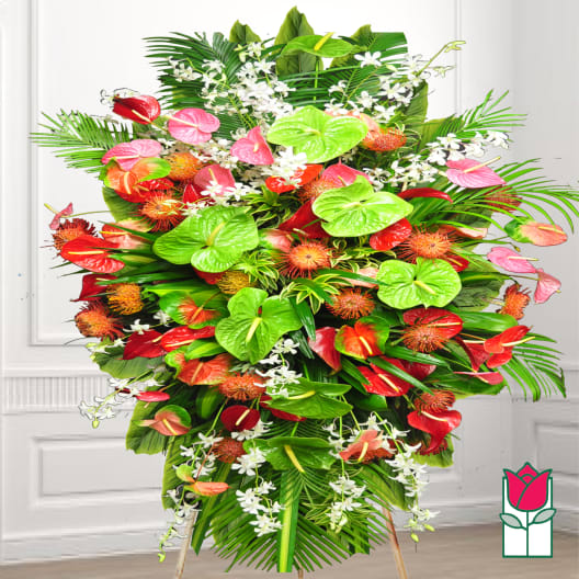 Large tropical standing arrangement with red and pink anthuriums