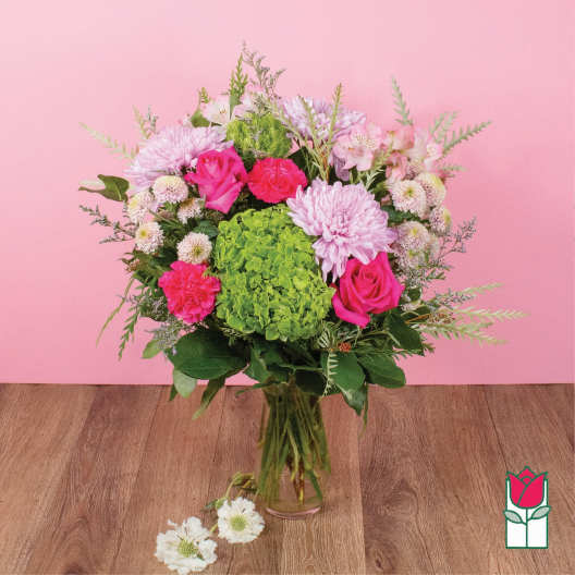 Pink and green mixed bouquet in a glass vase