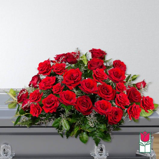 Large red rose casket spray with greenery