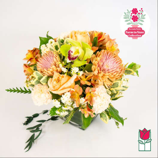 Mixed bouquet of peach and pink flowers in a vase