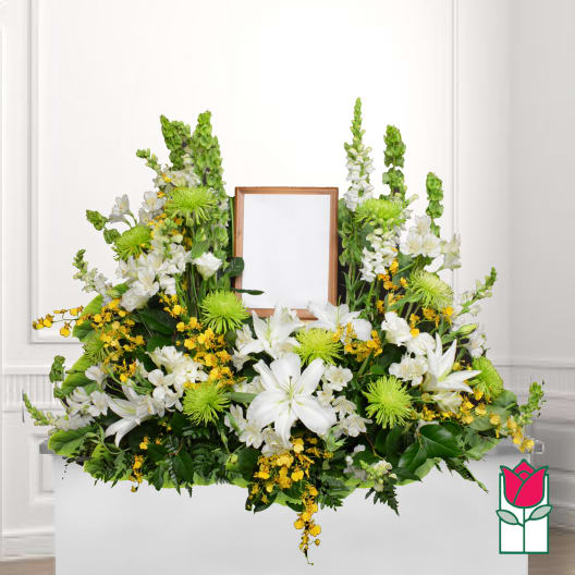 White and green floral funeral spray with a framed center opening