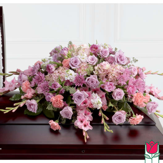 Large pink and lavender floral casket spray with roses and carnations