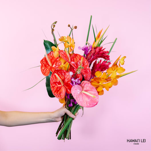 Tropical bouquet with red, pink, and orange anthuriums and orchids
