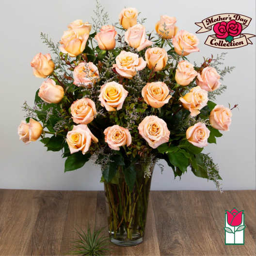 Peach roses arranged in a clear glass vase