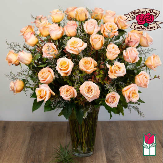 Peach roses arranged in a clear glass vase