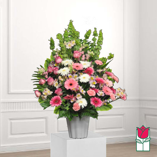 Pink and white mixed flowers arranged in a gray vase