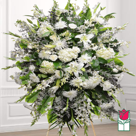 Large white funeral spray with lilies, roses, and chrysanthemums