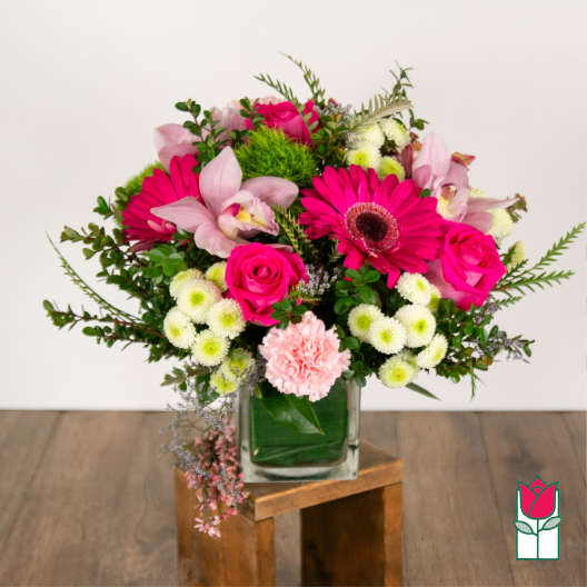 Pink and white mixed flower arrangement in a glass vase