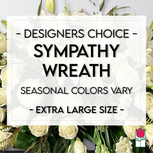 White sympathy wreath with roses and lilies