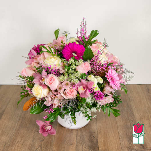 Pink and white mixed flower arrangement in a white vase