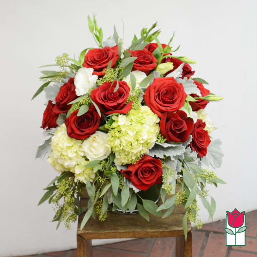 Bouquet of red roses and pale hydrangeas with greenery