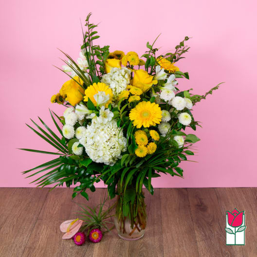 Yellow and white floral arrangement in a glass vase