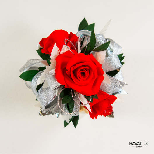 Red rose lei with silver ribbon and green leaves