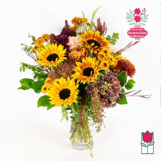 Sunflower and chrysanthemum bouquet in a clear glass vase