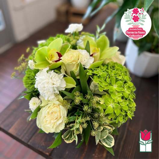 Bouquet of pale roses, green orchids, and white carnations