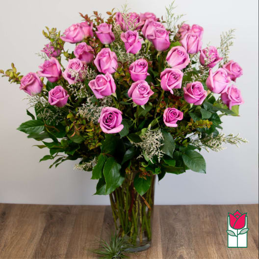 Pink roses arranged in a clear glass vase