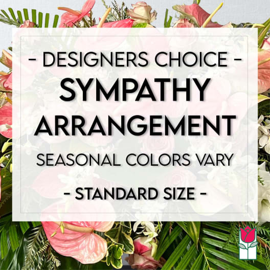 Sympathy arrangement with pink and white flowers and tropical leaves