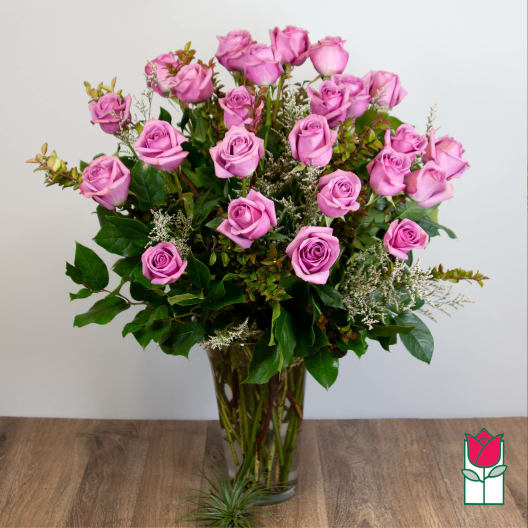 Pink roses arranged in a clear glass vase